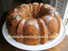 a bundt cake with icing on a white plate