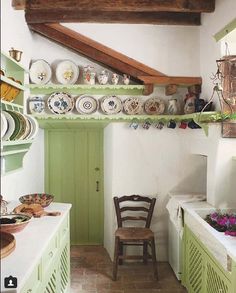 the world of interiors magazine cover with green cabinetry and plates on top of shelves