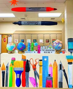 there are many different items on the wall in this school room that is decorated with markers, pens, and pencils