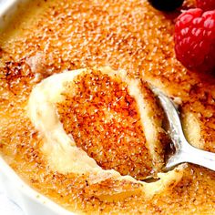 a bowl filled with pudding and raspberries