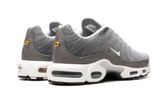 The Nike Air Max Plus SE “Flat Pewter” is a versatile colorway of the retro performance running and lifestyle sneaker with a neutral appearance.  The upper features a grey mesh construction with clear TPU overlays.  A small white jeweled Swoosh appears on each side of the shoe.  A classic yellow “TN” (Tuned Air) badge is found on the heel.  Underfoot, the shoe is mounted on a white foam midsole with visible Air units in the forefoot and heel.  Release date: February 11, 2023