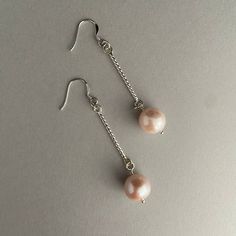 Would you like to have a pair of earrings as unique as you are.   Well these may be for you.  How gorgeous would these be with a wedding gown, or a party/holiday dress.   This is a gorgeous handmade sterling silver and genuine pearl pair of earrings.   The silver is a beautiful twisted wire.    The genuine pearl is a very nice quality, very large 12mm with pinky peachy tones.   They have a lot of luster and are very bright looking. All the rings and pearls swing separately which bring alot of mo Pearl Drop Dangle Earrings For Party, Evening Pearl Dangle Bridal Earrings, Evening Dangle Pearl Earrings With Pearl Charm, Dangle Pearl Earrings For Bridesmaid Gift, Pearl Dangle Earrings For Bridesmaid Gift, Elegant Hypoallergenic Pearl Earrings For Party, Pearl Long Drop Earrings For Party, Long Drop Pearl Earrings For Party, Hypoallergenic Pearl Earrings For Parties