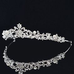 a tiara with crystal stones and pearls on the headband is seen in this image