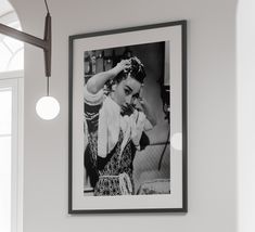 a black and white photo hanging on the wall