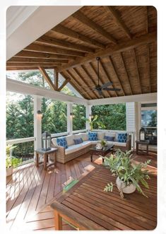 an outdoor living area with wood flooring and furniture