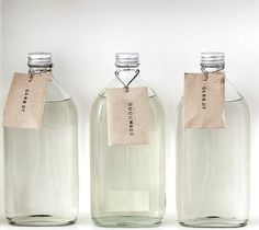 three empty glass bottles with labels on them