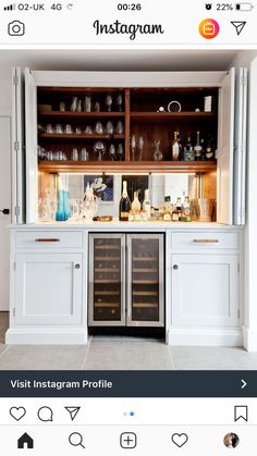 the instagram page on instagram shows an open cabinet with wine bottles and glasses