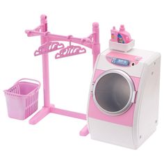 a pink and white toy washing machine next to a laundry basket