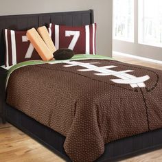 a football themed comforter set on a bed