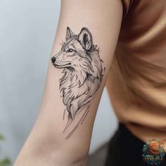 a woman's arm with a wolf tattoo on the left side of her arm