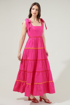 You will love the Hannah Hall Tiered Maxi Dress as much as we do! This pretty maxi dress has a square neckline followed by tied straps on the top that sits on a tiered maxi skirt. A smocked back and invisible zipper adorn the back. Perfect for a nice sunny day! - Tiered- Tie strap- Smocked- Zipper- Color: FuchsiaSize + Fit - Model is 5'8" and wearing size XS- Measurements taken from size S - Chest: 16 3/4"- Length: 47" Fabric Self:100% Cotton Lining:97% Polyester 3% Spandex Style Number STD13960 Pretty Maxi Dress, Tiered Maxi Skirt, Tiered Maxi Dress, Sunny Day, Invisible Zipper, Square Neckline, Summer Wear, Sundress