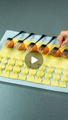 a person is decorating some desserts with forks