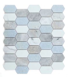 a white and grey mosaic tile with hexagonal tiles on the bottom, in different shades