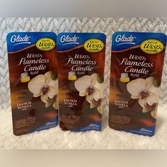 two packages of glade tea sitting on top of a white blanket