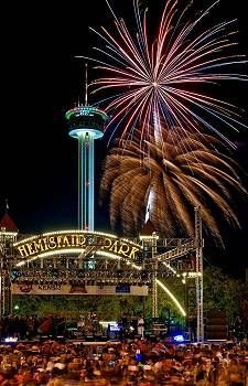 fireworks are lit up in the sky above a crowd