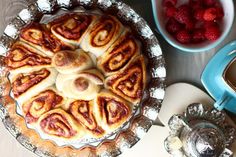 there is a pie on the table with raspberries and other desserts around it