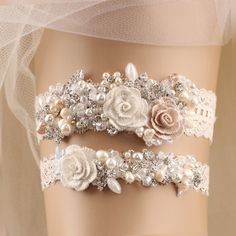 a white garter with flowers and pearls on it