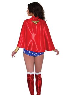 a woman in a red cape and blue shorts is standing with her hands on her hips