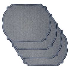 three placemats with scalloped edges on white background