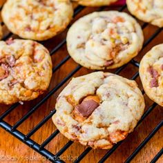 chocolate chip cookies cooling on a rack with other cookies in the backgroung