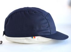 "A navy blue five panel strapback hat, made of medium-weight cotton, with a medium length brim which is unique on the caps market. Out in the woods or in the city, pedal like a madafaca while proudly wearing it. Ride fast through traffic, exercise your body and calm your mind ~ it's also what we believe in. The brim on this model is shorter than most 5 panel hats on the market. In our shop it's considered a medium sized brim (a little bit longer than the kepi brim and a little bit shorter than t Navy Cotton 5-panel Baseball Cap, Navy Adjustable 5-panel Baseball Cap, Navy Baseball Cap With Short Brim For Outdoor, 5 Panel Hat, Calm Your Mind, Five Panel, Panel Hat, Strapback Hats, In The Woods