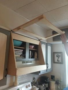 a man is fixing the ceiling in his kitchen