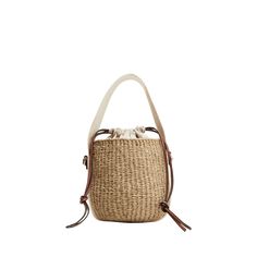 Chloe x Mifuko "Woody" bucket bag in straw, cotton, and leather  Branded flat web top handle  Flat shoulder strap Drawstring closure  Leather lining  Approx. 6.3"H x 6.7"W x 6.3"D Made in Italy Spring Handwoven Bucket Bag, Natural Color Bucket Bag For Daily Use, Beige Woven Straw Bucket Bag, Basket-shaped Bucket Bag In Woven Leather And Jute, Top Handle Jute Bucket Bag, Beige Crochet Bucket Bag With Leather Handles, Everyday Cream Bucket Straw Bag, Beige Handwoven Top Handle Bucket Bag, Beige Jute Basket Bucket Bag