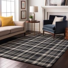 a living room with two couches and a rug on the floor in front of a fireplace