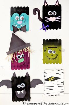 halloween crafts for kids made with popsicle sticks and construction paper, including bats, witches, and cats