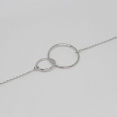 Dimensions Larger circle diameter - 17mm Smaller circle diameter - 13mm Necklace Length: 40 + 5cm (15.7 + 1.9inch) 45 + 5cm (17.7 + 1.9inch) 50 + 5cm (19.6 + 1.9inch) Silver necklace with intertwined circles. The elegant chain style will perfectly accentuate your neck and collarbone. With a simple yet luxurious design, this pendant can easily complement any look, giving it completeness and accent. Materials and designs give a special shine to this piece that will beautify you. As a present Jewel Infinity Necklace Gold, Tiny Cross Necklace, Dainty Cross Necklace, Gold Wave Ring, Eternity Necklace, Minimalist Necklace Gold, Necklace Clasps, Gold Cross Necklace, Circle Pendant Necklace