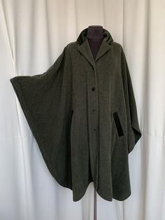 One size All measurements in centimiters. Length 110 Width 140 Perfect condition Green Cape Outerwear For Fall, Hooded Green Cape For Fall, Green Fall Cape Outerwear, Green Hooded Cape For Fall, Green Cape For Fall, Green Winter Cape Outerwear, Green Long Sleeve Winter Cape, One-size Wool Winter Cape, Wool Cape One Size For Winter