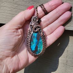 This is a stunning natural Shattuckite stone that I wrapped up all nice and snug in solid copper wire and then oxidized (antiqued) the copper to bring out the texture and pattern of the wire work. Truly and heirloom piece of wearable art to pass down for generations! It measures approximately 2 - 3/4 inches long by 1 - 1/4 of an inch wide and you can purchase just the pendant, add a free adjustable leather or vegan cotton cord, or purchase a matching copper chain to customize it to your liking. This would make a great addition to your jewelry collection or a timeless, unique gift for a friend or loved one! SHATTUCKITE is associated with the throat and third eye chakras and it known to encourage us to be less emotionally-driven, and instead to be realistic and curious.  It gently reminds us Handmade Chrysocolla Oval Pendant Jewelry, Handmade Oval Pendant With Gemstone, Handmade Chrysocolla Pendant Jewelry, Chrysocolla Large Pendant Jewelry For Gift, Chrysocolla Large Pendant Jewelry Gift, Chrysocolla Oval Pendant Necklace As Gift, Chrysocolla Oval Pendant Necklace For Gifts, Chrysocolla Necklace With Large Pendant As Gift, Oval Pendant Chrysocolla Necklace For Gift