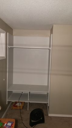 an empty closet is shown with shelves and other items on the floor in front of it