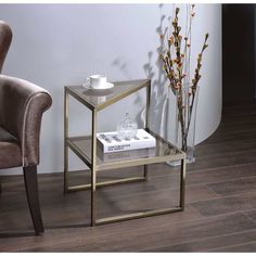 a glass table with a book on it next to a chair