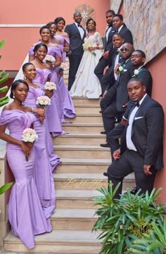 a group of people that are standing in front of some stairs with flowers on them