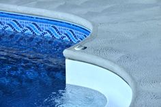 an empty swimming pool with blue water