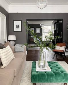 a living room filled with furniture and a large vase on top of a coffee table