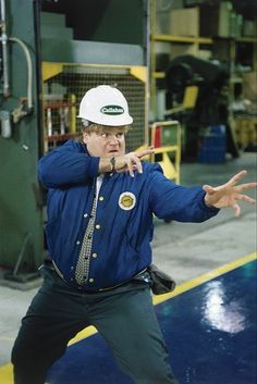 a man wearing a hard hat and blue jacket