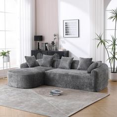 a living room filled with furniture and a large rug on top of a hard wood floor