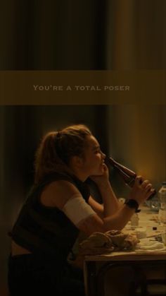 a woman sitting at a table holding a wine bottle in front of her face with the words you're a total power written on it