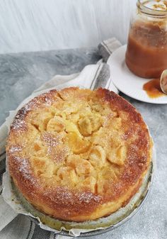 a cake sitting on top of a white plate next to a jar of peanut butter