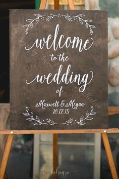 a welcome sign on an easel for the couple's wedding day at their reception