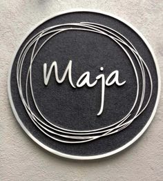 a black and white sign with the word maja in cursive writing on it