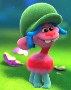 a cartoon character in a green hat and red dress standing on grass with other objects