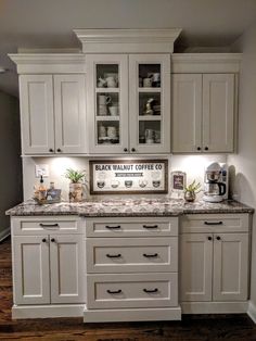 a kitchen with white cabinets and granite counter tops