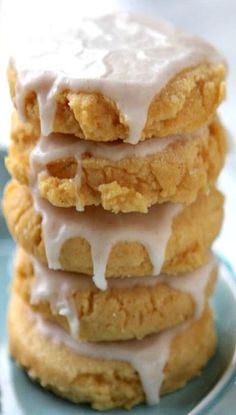 a stack of cookies covered in frosting on top of a blue plate