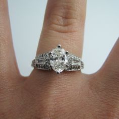 "For sale: (1) d863 Stunning 14k White Gold Engagement Ring PLEASE READ ENTIRE DESCRIPTION BEFORE PURCHASING Pre-owned item. Good condition. Please see pictures for details. Sold as is, as seen on pictures. This ring contains 35 diamonds. The centerpiece is oval cut; two diamonds are baguette cut; 32 are round cut. This ring is stamped on the inside of the shank. Has GIA Certificate on center oval diamond. See picture for details. Specifics: 14k White gold Diamonds: 1.40TCW Size: 6.75 (U.S.) Wid Elegant Gia Certified Marquise Wedding Ring, Classic Marquise Sterling Silver Wedding Ring, Heirloom 14k White Gold Jewelry, Gia Certified, Elegant Marquise Gia Certified Jewelry, Gia Certified Elegant Marquise Cut Ring, Gia Certified Marquise Platinum Jewelry, Elegant Gia Certified Marquise Cut Rings, Classic 14k White Gold Gia Certified Jewelry, Classic Marquise Cut Diamond Ring Gia Certified