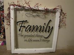 a framed sign that says family the greatest things in life aren't things on it