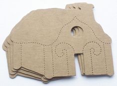 several pieces of cardboard cut out to look like an elephant with a house on it