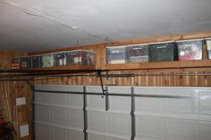 an overhead garage door with pictures on the wall above it and in between them is a red fire hydrant